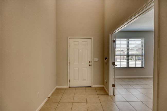 Foyer entrance featuring light tile patterned flooring and baseboards | Image 5
