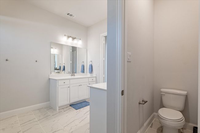 Bathroom featuring marble finish floors, vanity, toilet, and baseboards | Image 25