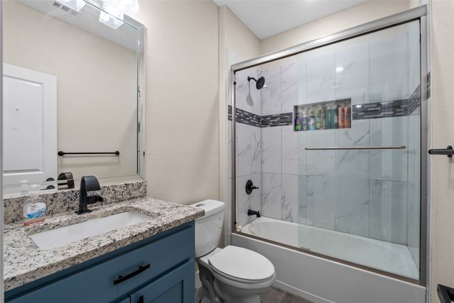 Full bathroom with vanity and bath / shower combo with glass door | Image 27