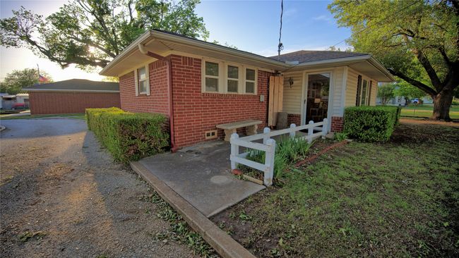 View of front of home featuring brick siding and fence | Image 22