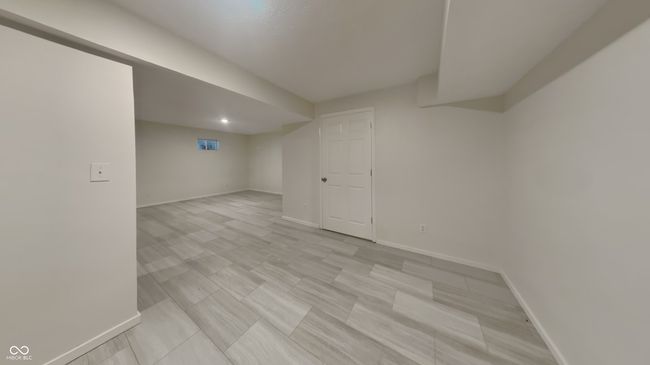 finished basement with baseboards | Image 16