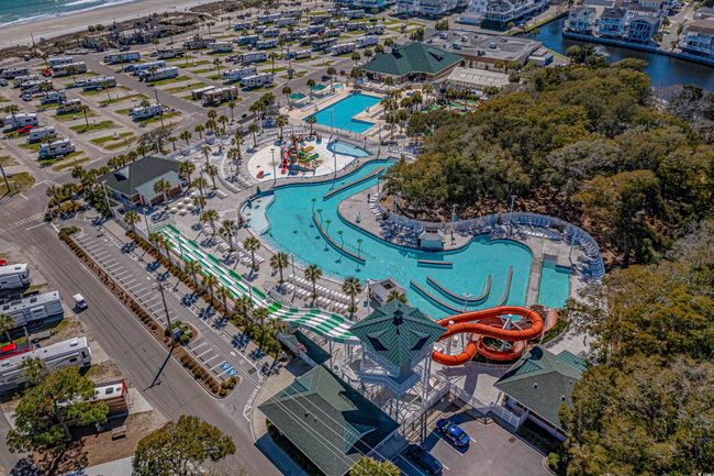 Drone / aerial view of a pool area and a nearby body of water | Image 30