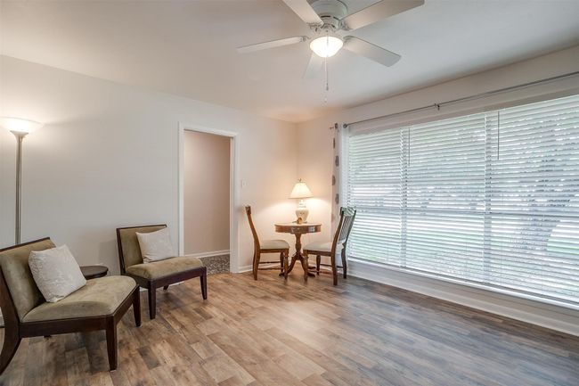 Living area featuring light wood-type flooring and a ceiling fan | Image 11