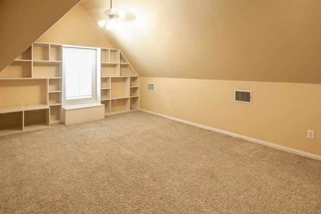 Additional living space featuring visible vents, baseboards, carpet flooring, and vaulted ceiling. Half bath | Image 23