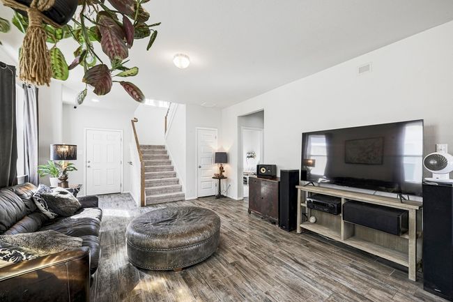 Highly desirable wood-like tile flooring runs through the main floor living, kitchen, and dining areas. | Image 5
