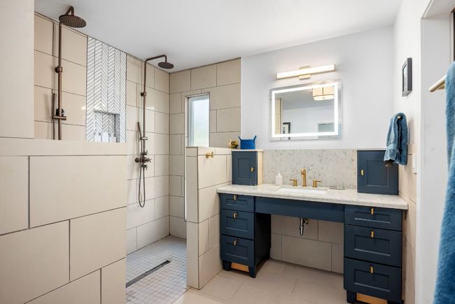 Full bath with tile patterned flooring, walk in shower, tasteful backsplash, and vanity | Image 16