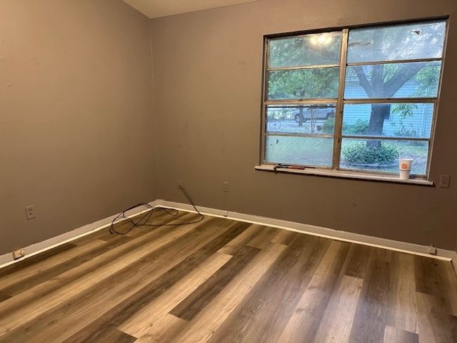 Spare room with wood finished floors and baseboards | Image 4