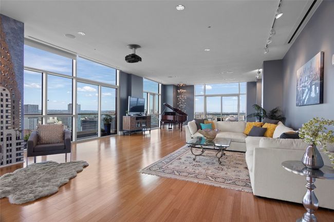 Living area bathed with natural light, featuring floor-to-ceiling windows that showcase the spectacular views of the city, hill country and the Capitol | Image 4