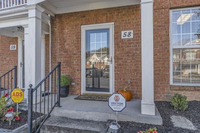 A covered front porch greets you | Image 2