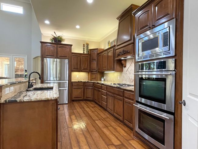 Gourmet Kitchen features Stainless steel appliances and granite counter tops. | Image 15