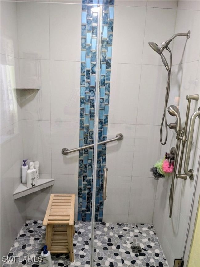 Full bathroom with tile walls and a stall shower | Image 24