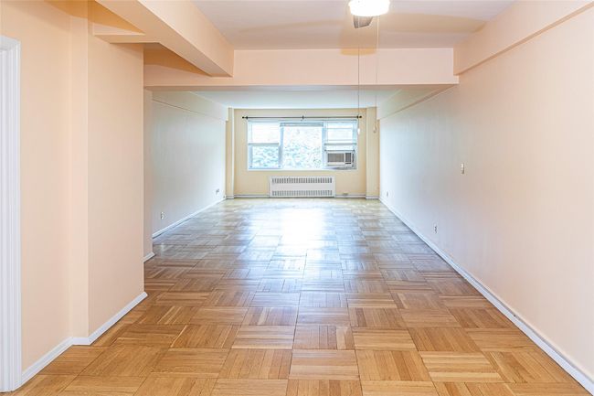 The apartment has a roomy entry foyer that opens to sunlit living room | Image 5