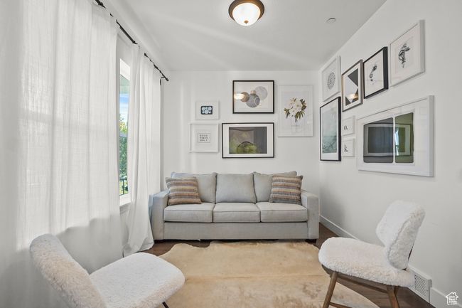 Living room featuring baseboards and wood finished floors | Image 6