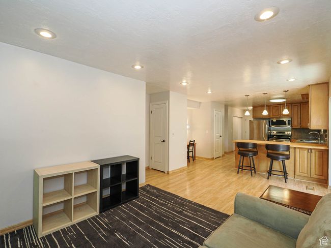 Living area featuring baseboards, recessed lighting, and light wood-style flooring | Image 15