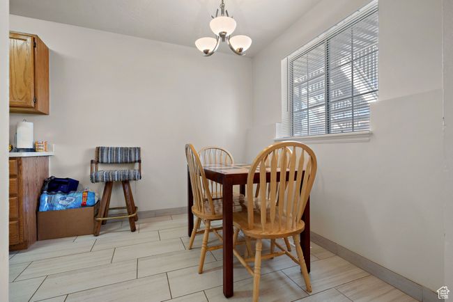 Dining space with a chandelier and baseboards | Image 24