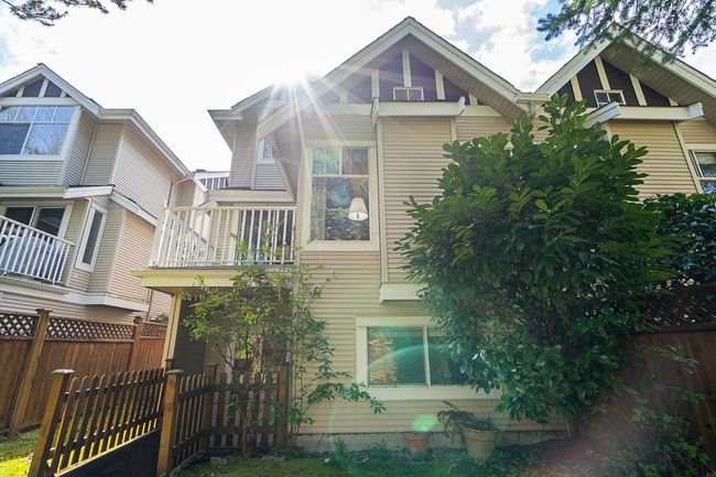 Rear view of house with fence and a balcony | Image 30