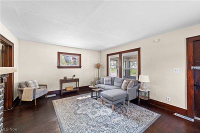 Living room with dark hardwood / wood-style flooring and a stone fireplace | Image 3