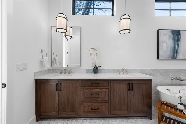 Bathroom featuring a freestanding bath, double vanity, and a wainscoted wall | Image 10
