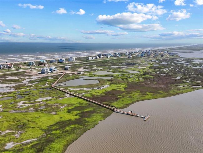 Your backyard isn’t just sand—it’s the Drum Bay Nature Preserve. This aerial shows the community’s private boardwalk and kayak launch leading to a protected sanctuary perfect for fishing, crabbing, and sunset paddles. It's a rare fusion of luxury and untouched coastal beauty. | Image 5