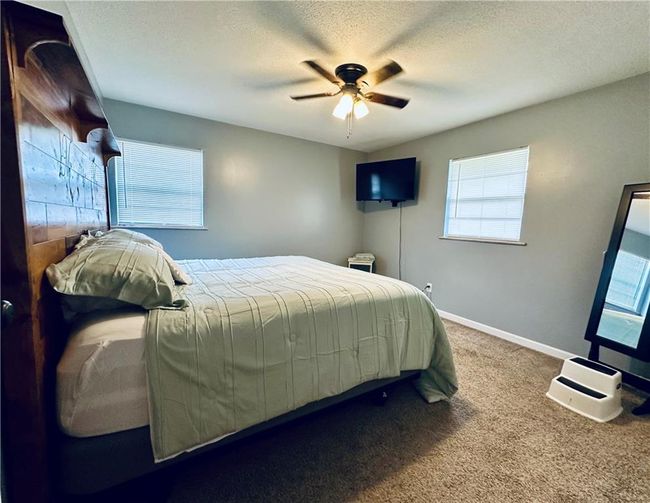 Bedroom featuring carpet, a textured ceiling, ceiling fan, and baseboards | Image 13