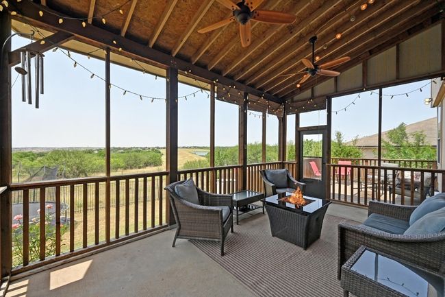 A look at the enclosed patio space featuring multiple ceiling fans and plenty of space for your favorite outdoor decor. | Image 20