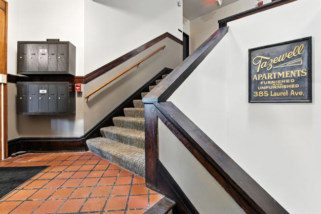 Original wood trim and vintage tile floors enhance the character of the well-maintained common areas. | Image 7
