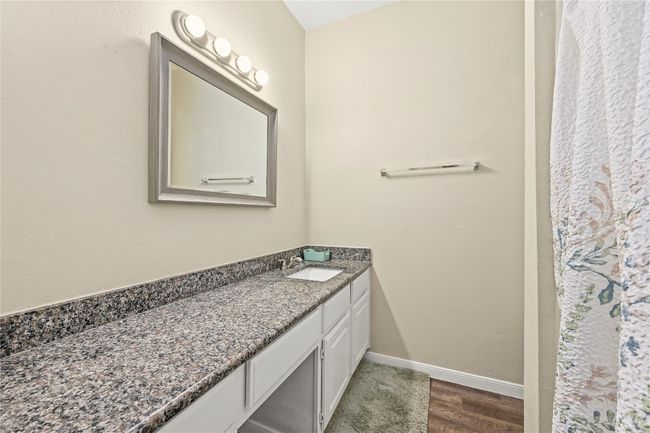 Bathroom featuring vanity, baseboards, and wood finished floors | Image 15