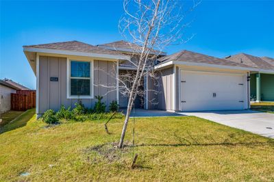 Ranch-style home featuring a garage and a front lawn | Image 2