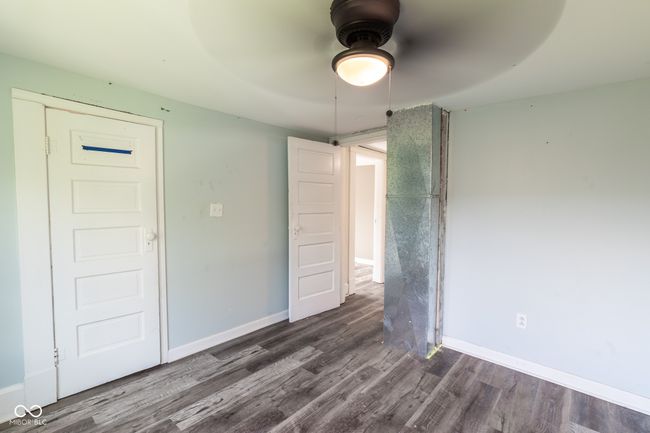 spare room with baseboards, ceiling fan, and dark wood-style floors | Image 28