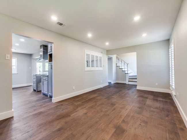 Unfurnished living room featuring stairway, recessed lighting, dark wood-style flooring, and baseboards | Image 11