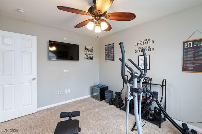 Workout room featuring carpet floors, a ceiling fan, and baseboards | Image 36