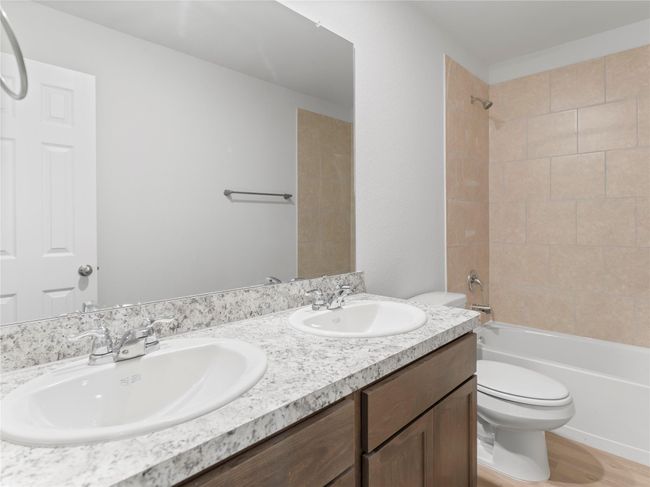 Elegant upstairs bathroom featuring a double-sink vanity. | Image 15