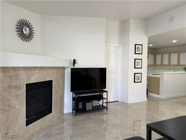 Living room featuring marble finish floor, baseboards, a tile fireplace, and recessed lighting | Image 12