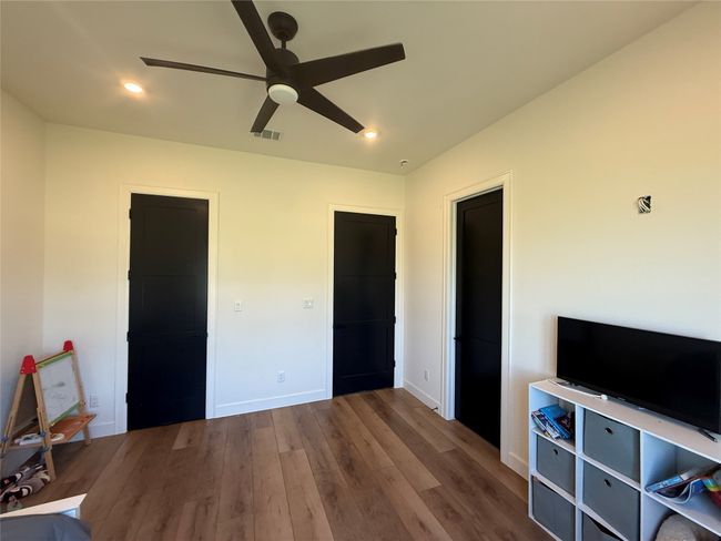 Unfurnished bedroom featuring wood finished floors, recessed lighting, and ceiling fan | Image 8