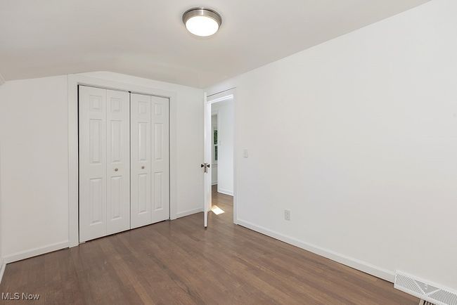 Unfurnished bedroom with a closet and wood-type flooring | Image 32