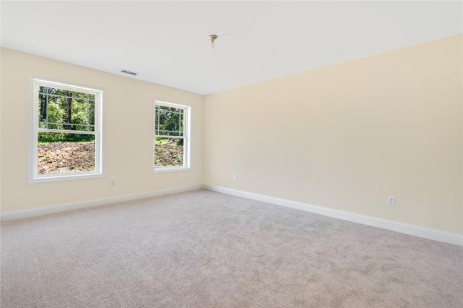 Unfurnished bedroom with carpet, baseboards, visible vents, a ceiling fan, and a closet | Image 27