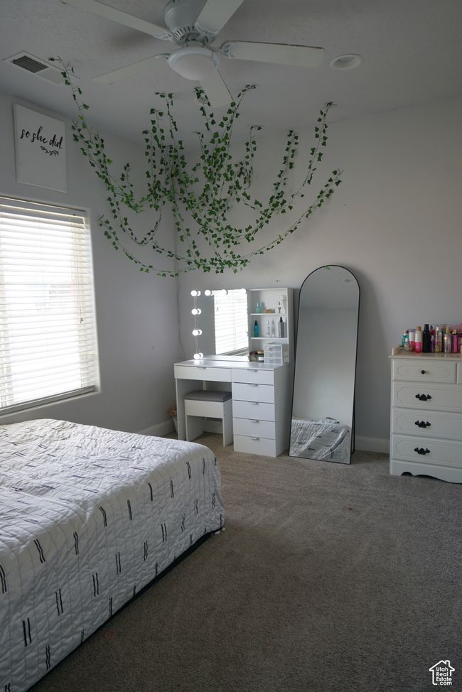 Unfurnished bedroom featuring a ceiling fan, carpet, and visible vents | Image 17