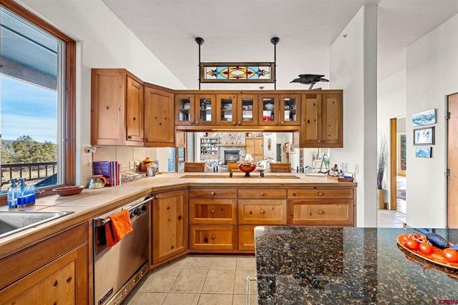Bar top seating and large island with granite countertop | Image 11