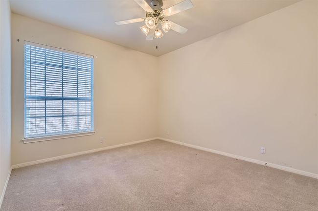 Secondary bedroom with ceiling fan, facing the side of the house | Image 25