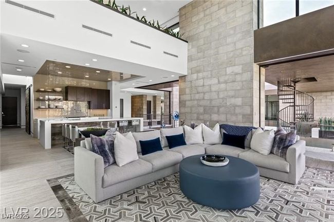 Living room featuring recessed lighting, stairs, and a towering ceiling | Image 16