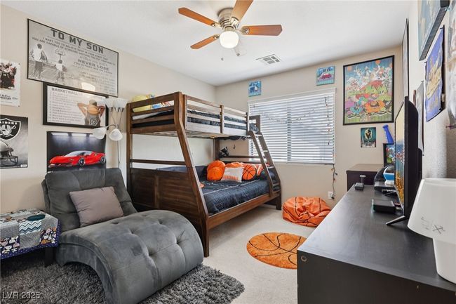 Carpeted bedroom featuring a ceiling fan | Image 39