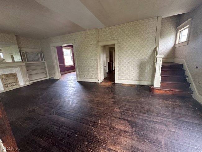 Unfurnished living room with dark hardwood / wood-style flooring | Image 7