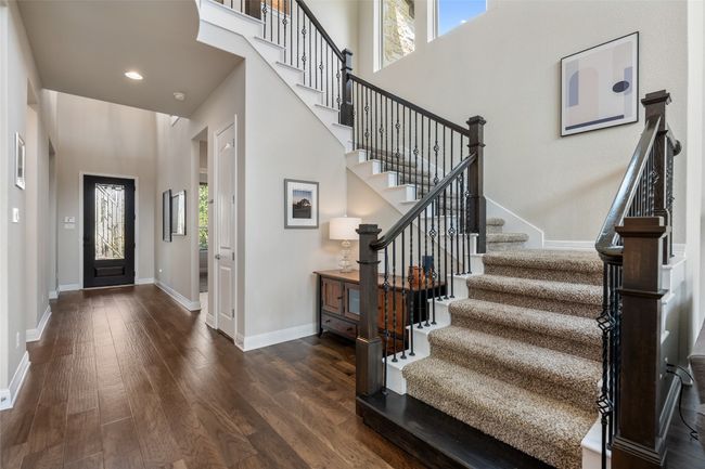 Entryway with stairs, wood finished floors, a towering ceiling, and recessed lighting | Image 23