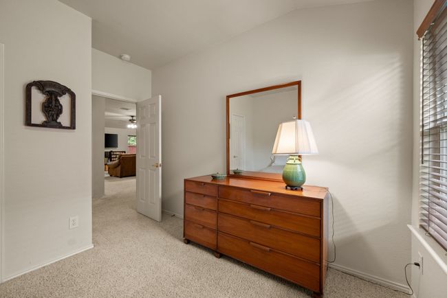 Light-filled bedroom with two windows, soft carpet, and a simple, inviting setup. | Image 30