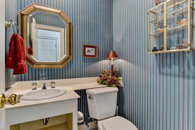 Half bath featuring wallpapered walls, a sink, and toilet | Image 26