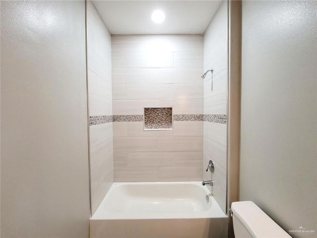 Bathroom with toilet and shower combination | Image 16