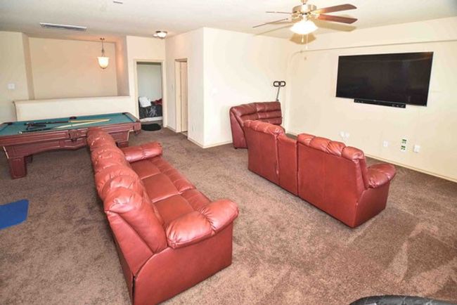 Living area featuring carpet, billiards, a ceiling fan, and baseboards | Image 24