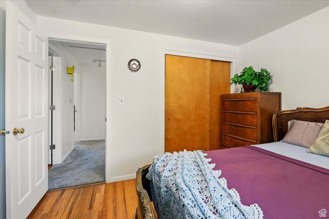 Bedroom featuring wood finished floors and a closet | Image 16