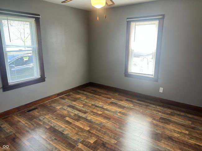 spare room with dark wood finished floors, visible vents, a wealth of natural light, and ceiling fan | Image 7