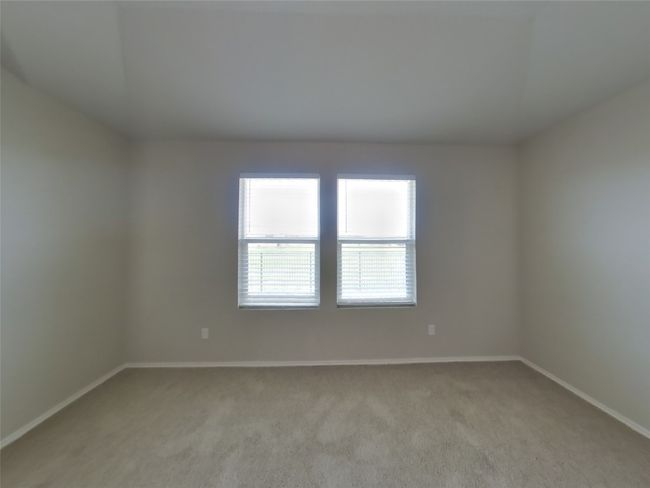 Spare room featuring light colored carpet and baseboards | Image 6